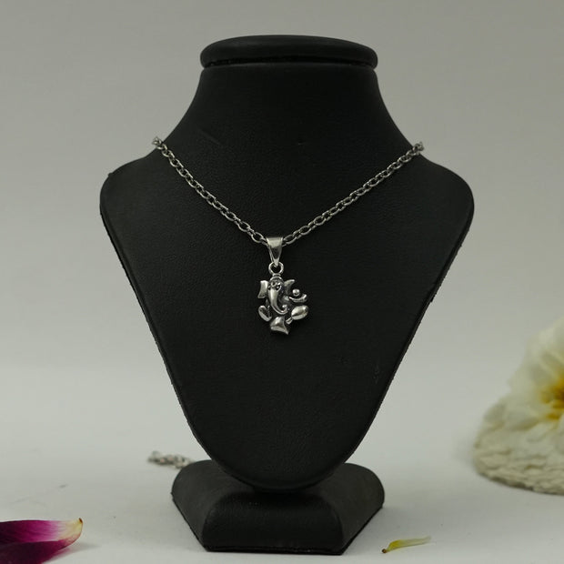 My Guru Ji silver plated brass Lord Ganesha pendant on a black display stand, featuring detailed devotional artistry.