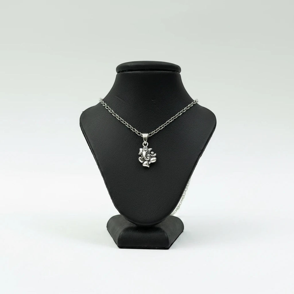My Guru Ji silver plated brass Lord Ganesha pendant featuring fine detailing on a black display bust