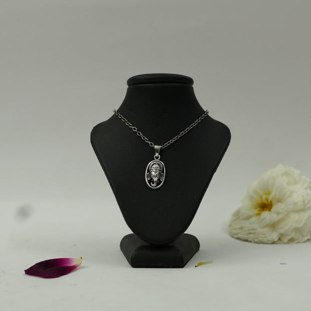 My Guru Ji silver plated brass oval pendant featuring a detailed Lord Ganesha face on a black display bust