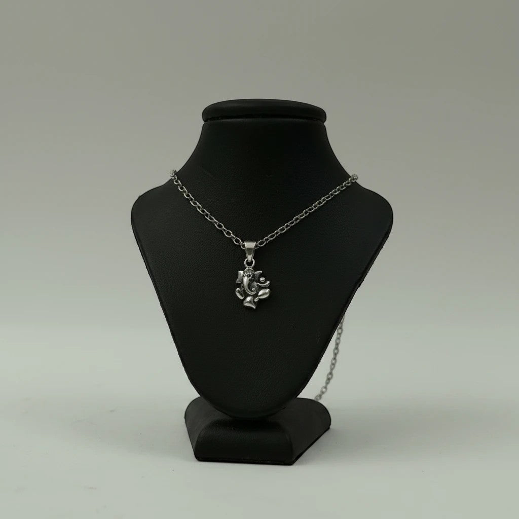 My Guru Ji silver plated brass Lord Ganesha pendant on a black display stand, featuring detailed devotional design.