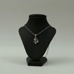 My Guru Ji silver plated brass Lord Ganesha pendant on a black display stand, featuring detailed devotional design.