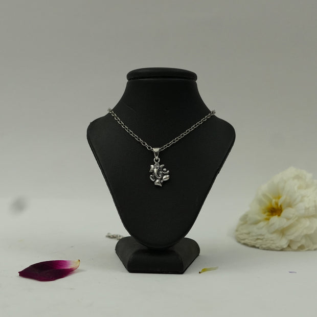 My Guru Ji silver plated brass Lord Ganesha pendant on a black display stand, featuring fine devotional detailing.