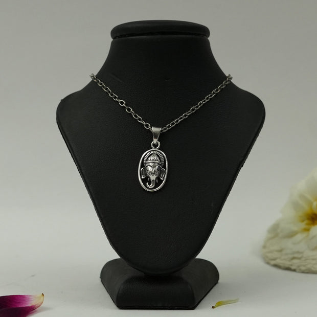 My Guru Ji silver plated brass oval pendant featuring a detailed Lord Ganesha face design on a black display stand.