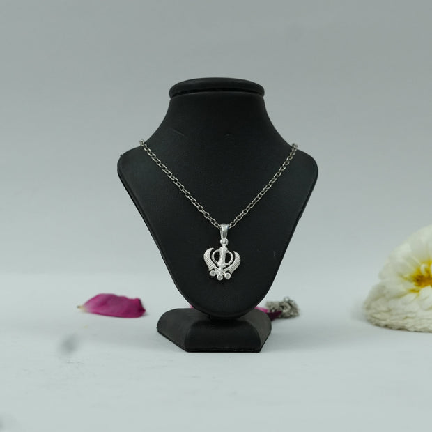 My Guru Ji silver plated brass Khanda pendant on a black display stand, featuring intricate spiritual symbol detail.