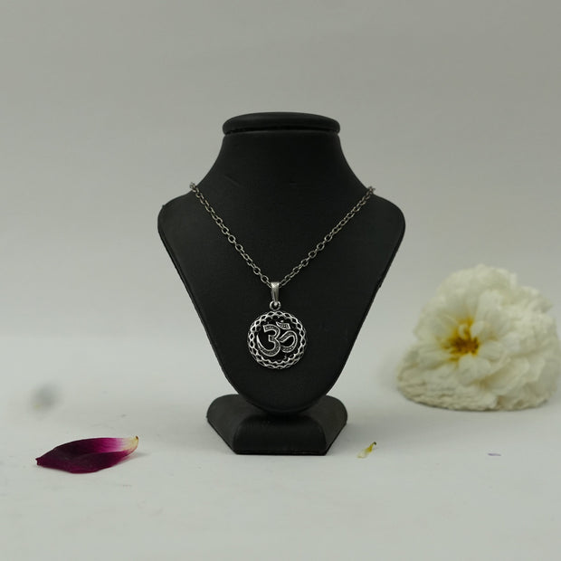 My Guru Ji silver plated brass round Om pendant featuring intricate detailing on a black display bust