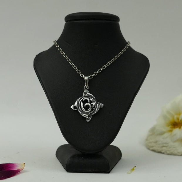 My Guru Ji silver plated brass Om pendant featuring a traditional circular spiritual symbol on a black display bust.