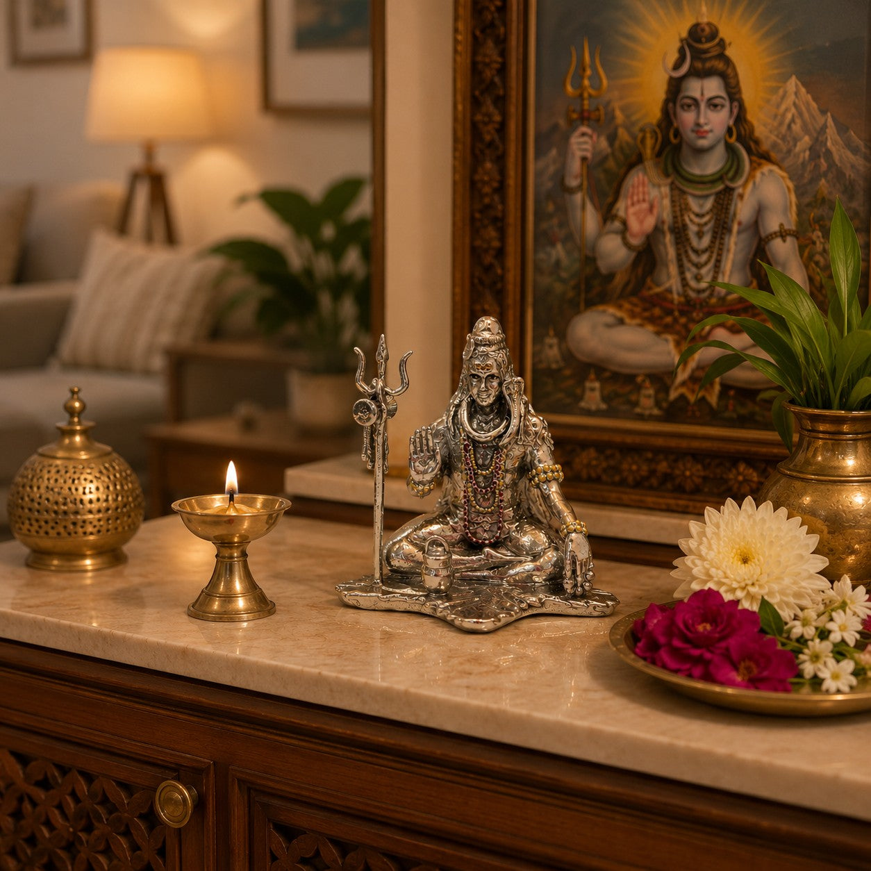 My Guru Ji silver finish brass Lord Shiva idol in meditative pose with Trishul and Shivling on a home temple altar.