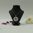 My Guru Ji silver-finish Tamil OM pendant featuring a circular frame with crystal accents on a black display bust.