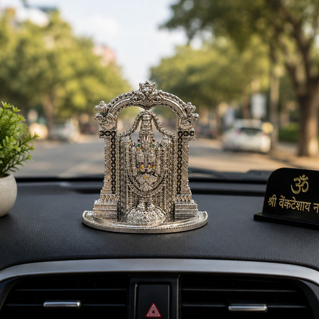 My Guru Ji silver finish brass Lord Tirupati Balaji idol with temple arch displayed on a car dashboard