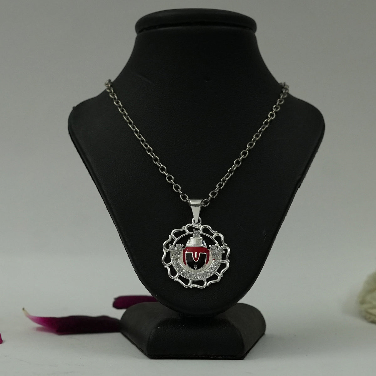 My Guru Ji Tirupati Balaji silver finish pendant with red enamel detailing on a black display stand