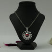 My Guru Ji Tirupati Balaji silver finish pendant with red enamel detailing on a black display stand
