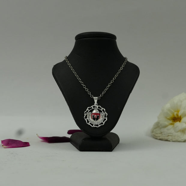 My Guru Ji Tirupati Balaji spiritual pendant with a silver finish and red devotional detailing on a display stand.